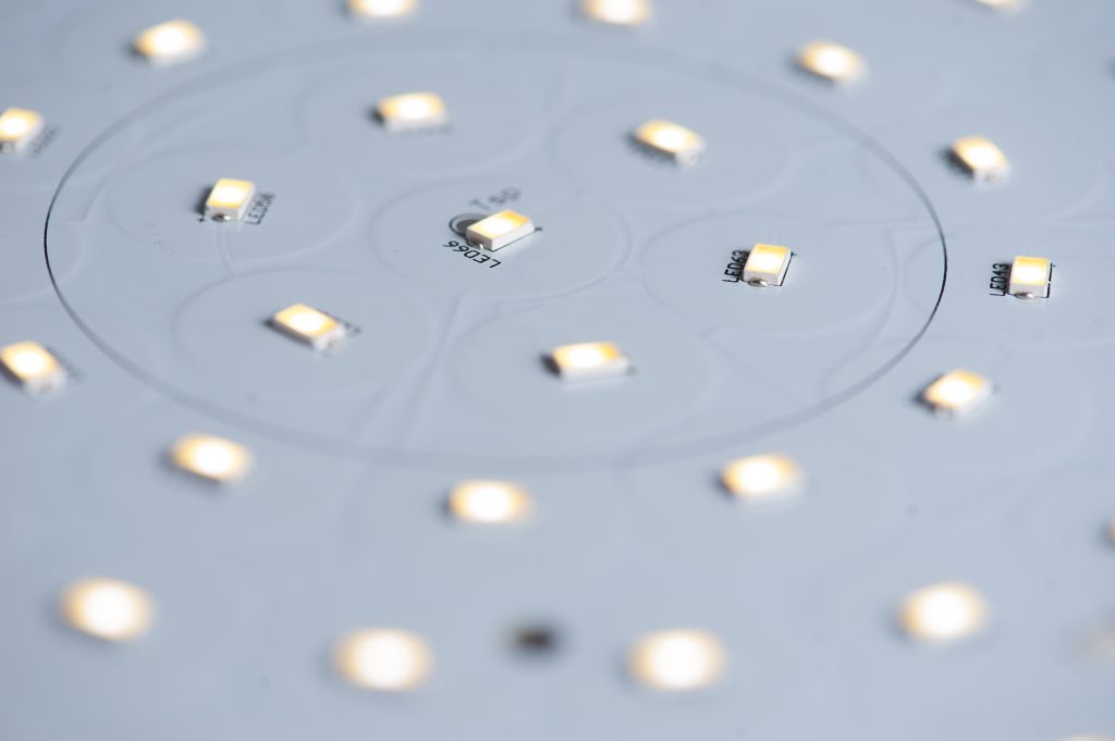 A close-up photograph of an array of LEDs (light-emitting diodes) arranged on a panel. The LEDs emit bright light and are organized in a grid pattern, suggesting a display or lighting application. The image showcases the uniformity and brightness of the LED array.