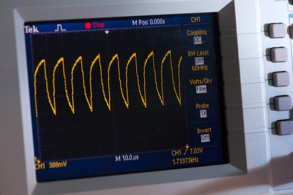 A close-up photograph of a specialised industrial testing machine with a visible graph display. The machine is configured for testing purposes, possibly evaluating the performance or properties of materials or components. The graph display indicates data collected during the testing process, highlighting the analytical capabilities of the equipment.