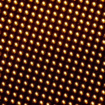 A close-up photograph of an LED circuit board. The board features multiple LEDs and intricate electronic components, indicating its use in lighting or display technology. The image highlights the precision and complexity of modern electronic circuitry