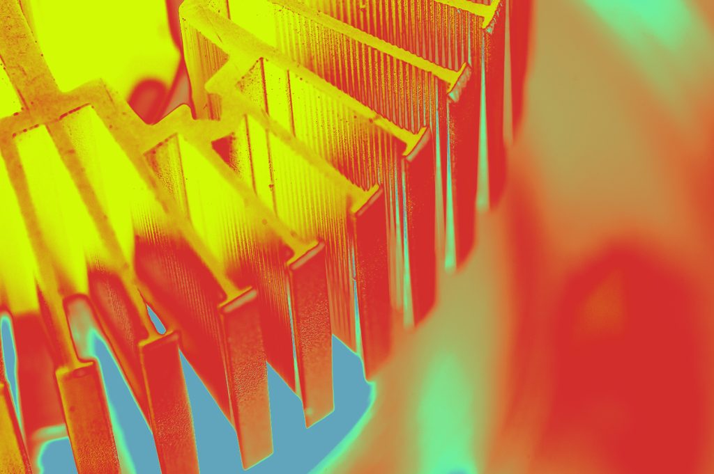 A thermal management system comprising various cooling components, including heat sinks and fans, arranged on a circuit board. The components are designed to dissipate heat generated by electronic devices, ensuring optimal performance and longevity.