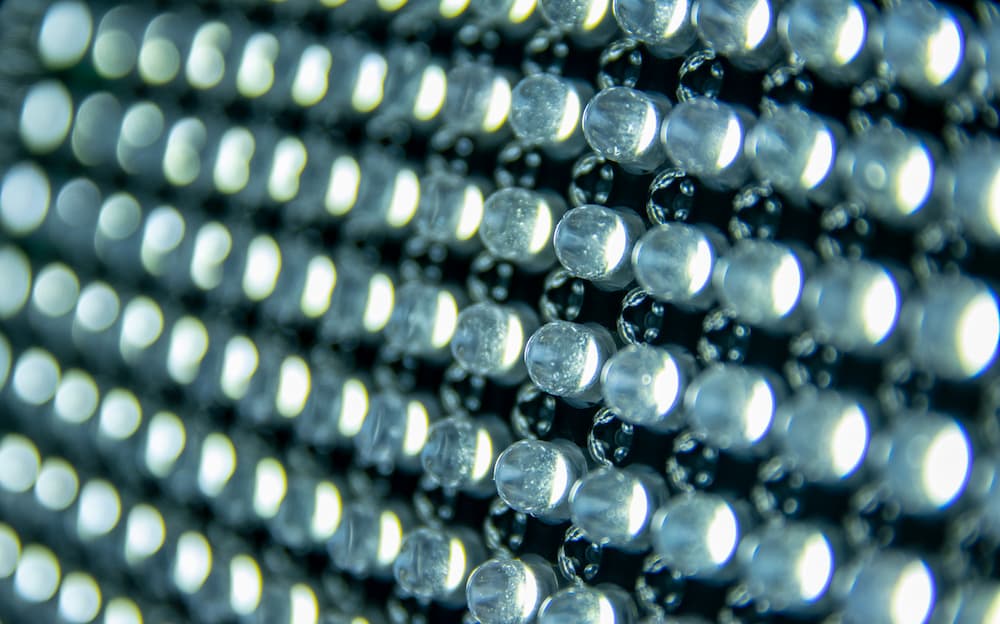 A close-up photograph of a board filled with numerous LEDs. The LEDs are arranged in a grid pattern on the circuit board, highlighting the precision and complexity of electronic design and manufacturing.